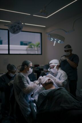 Équipe médicale en train de réaliser une greffe de cheveux sur un patient.